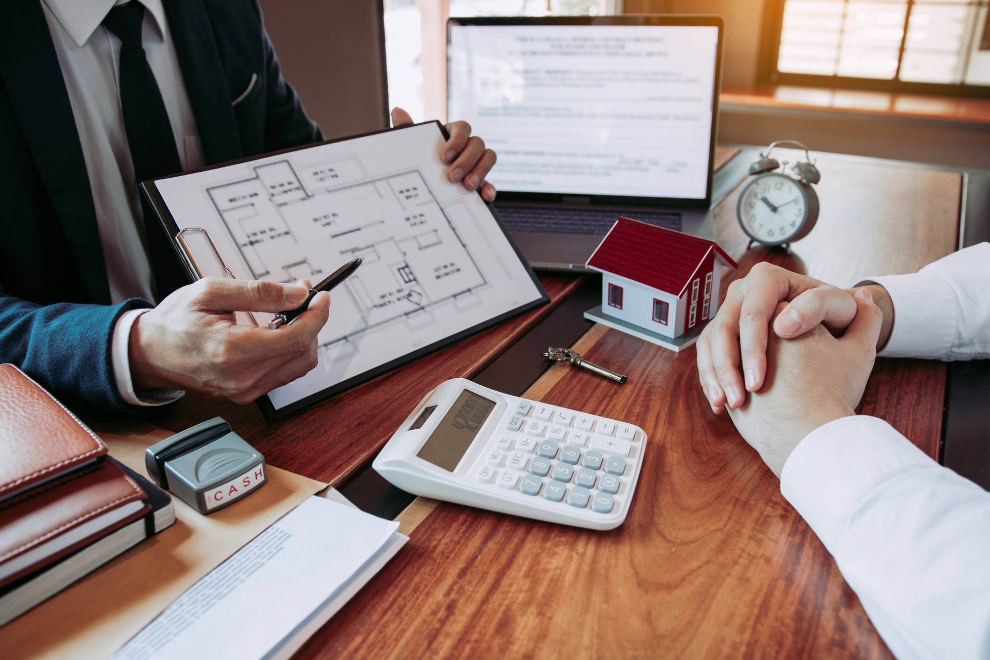 Agents are using pens pointing to blueprint home design